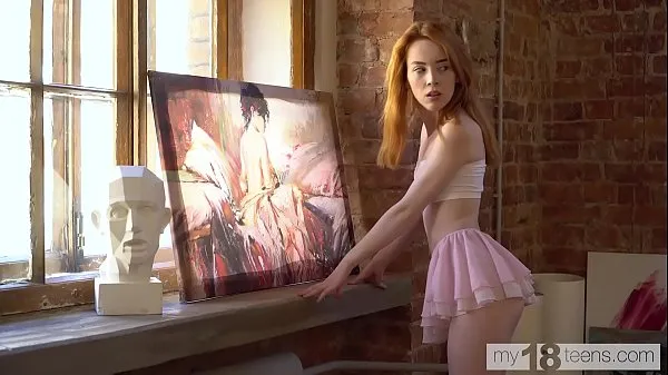 Cute redhead Lottie Magne fingering her pussy in the art place